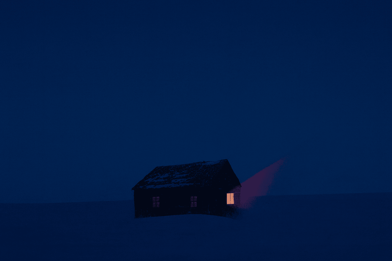 A single lit house alone in the snow at night